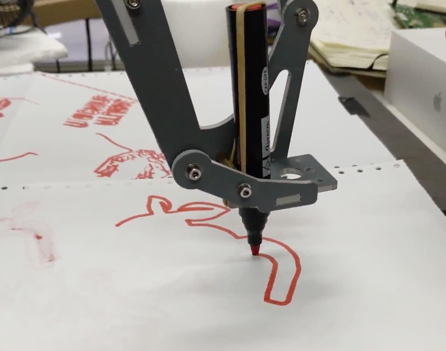 Robotic arm writing company's logo